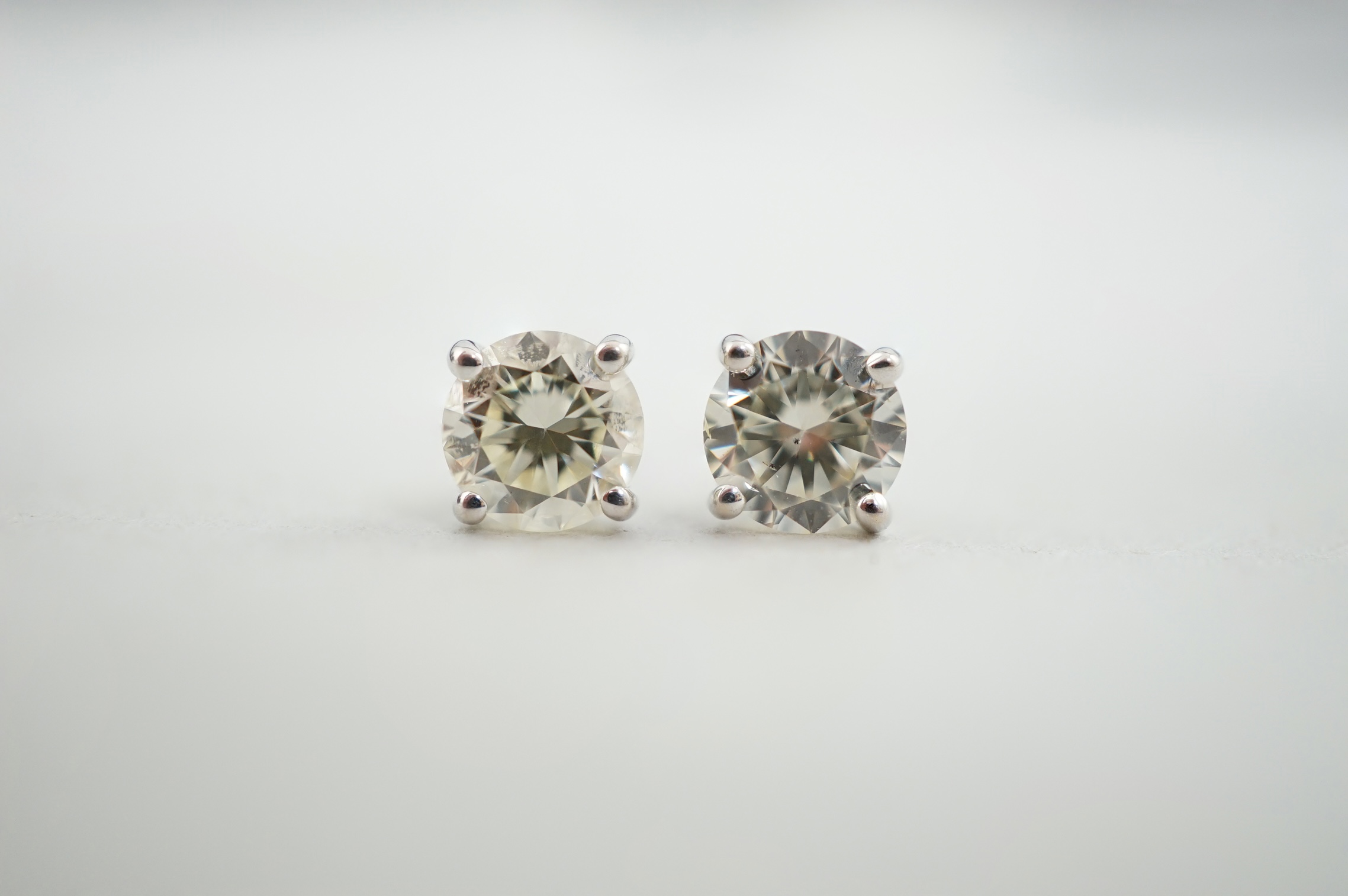 A pair of 18k white gold and solitaire diamond set ear studs